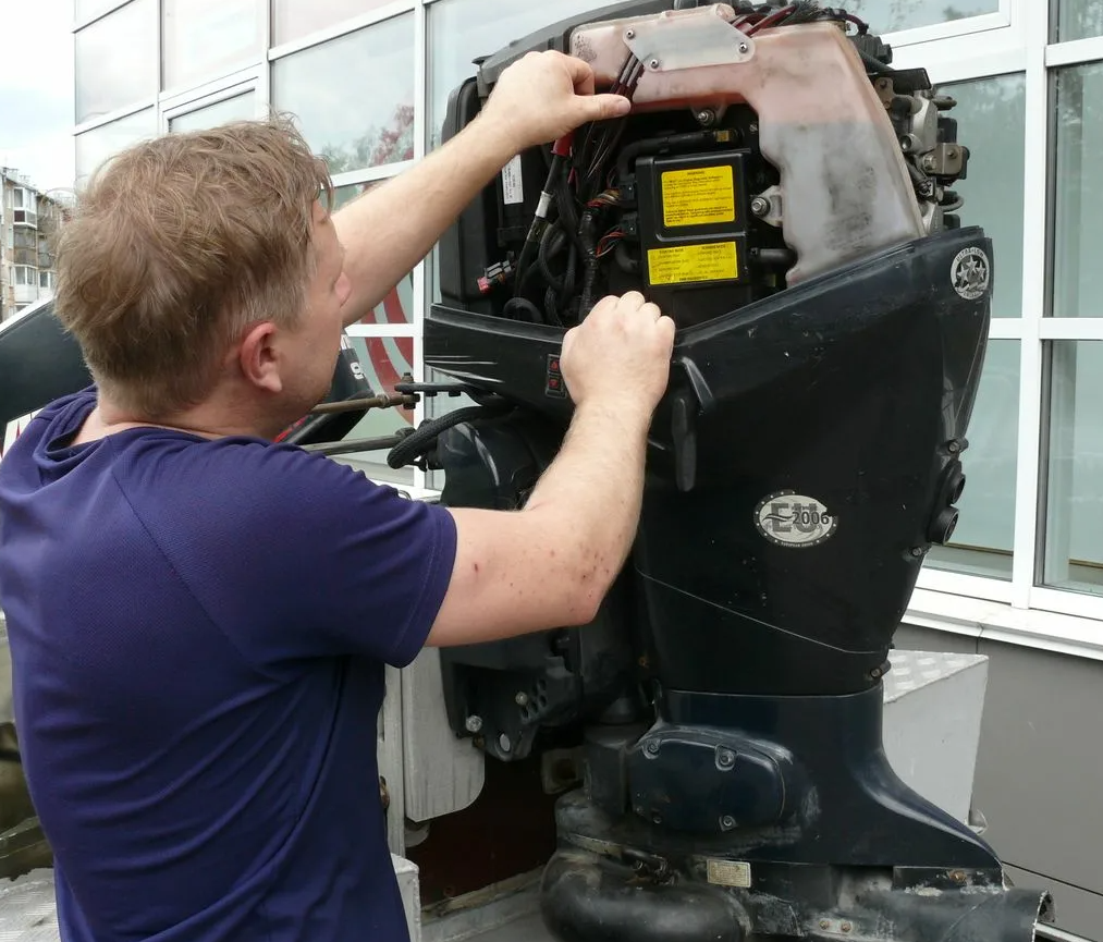 Marine service crew on dock inspecting an engine